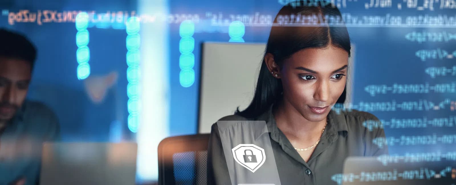 Focused woman using smartphone with digital security icons and coding overlays in modern tech workspace.